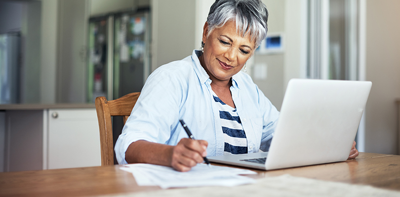 Cropped shot of a senior woman using a laptop to do the household finances