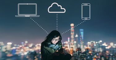 Asian Woman Using Mobile Phone on Rooftop