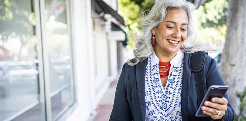 A mature Mexican businesswoman texting