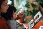 Young Asian mother and child having online medical consultation with doctor on video call