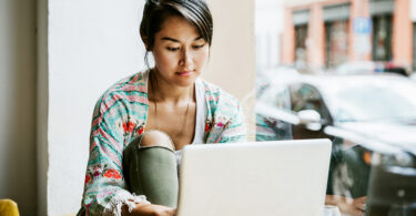 Woman using laptop indoors