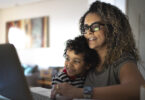 Mother and son using laptop computer together