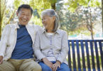 Older couple sitting together on bench