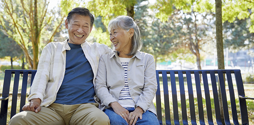 Older couple sitting together on bench