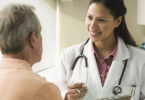 Female doctor speaking with male patient