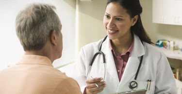 Female doctor speaking with male patient