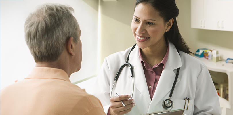 Female doctor speaking with male patient