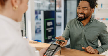 Man using phone to pay at the pharmacist