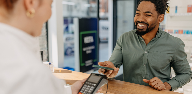 Man using phone to pay at the pharmacist