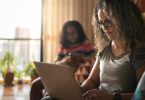 Woman wearing glasses using laptop.