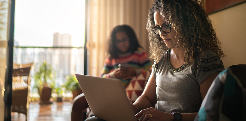 Woman wearing glasses using laptop.