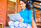 Woman sitting outside using tablet
