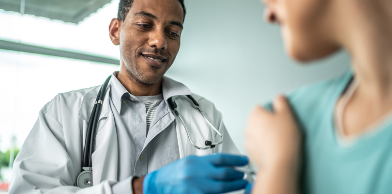 Doctor administering a vaccine to his patient