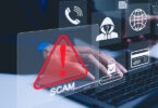 Person using laptop with graphics of warning symbols overlaid on top