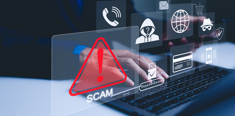 Person using laptop with graphics of warning symbols overlaid on top