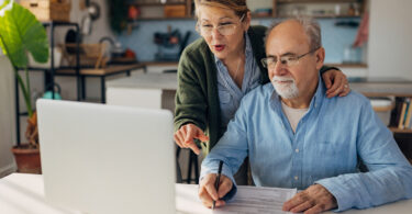 Senior couple looking at laptop computer together