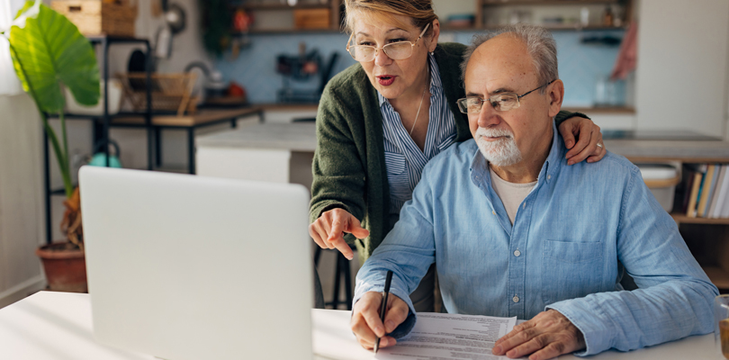 Senior couple looking at laptop computer together