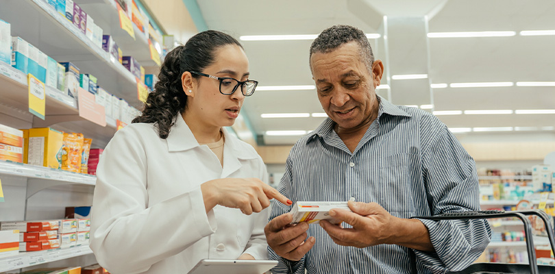 Pharmacist explaining a medication to a customer